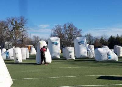 Paintball Player using the bunkers for cover at Cousins Paintball.