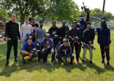 Paintball players posing for a group photo before battle on the field at Cousins Paintball.